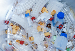 Healthcare worker applying medical labels to specimen containers to reduce clinical waste and improve patient safety