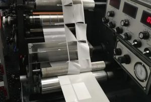 Close-up of adhesive oozing from pressure-sensitive label edges due to incorrect viscosity