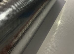 Durable bright silver PET self-adhesive label on industrial metal drum resisting water and UV