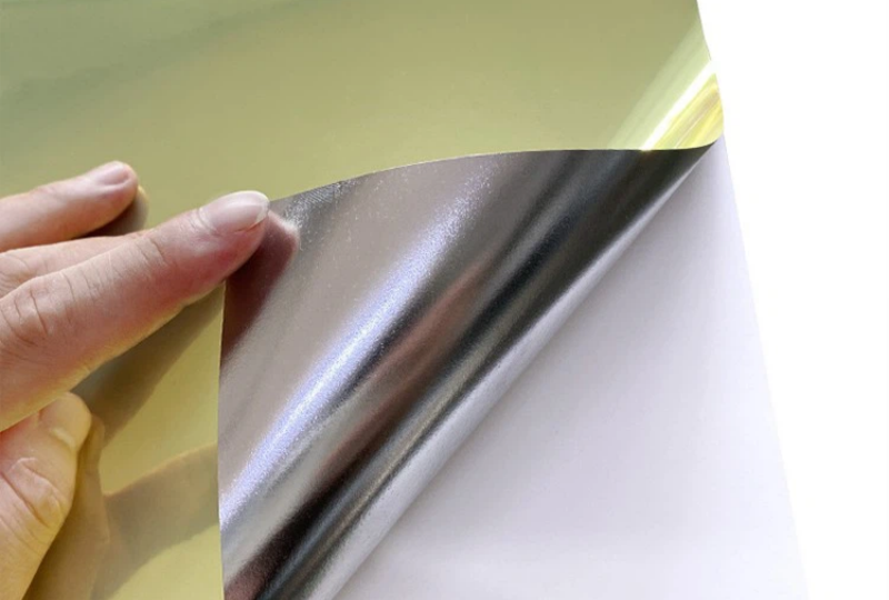 Close-up of GemmyLabel Gold PET Label Material - Durable self-adhesive gold sticker with scratch-resistant metallic coating