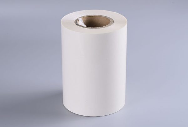 Transparent cellulose self-adhesive label material showing smooth surface and wood fiber composition for eco-friendly packaging