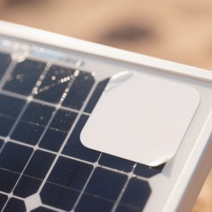 High-adhesion solar panel label with glossy surface in desert environment