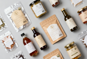 A professional flat-lay collection of various custom food packaging labels for jars, bottles, and pouches.