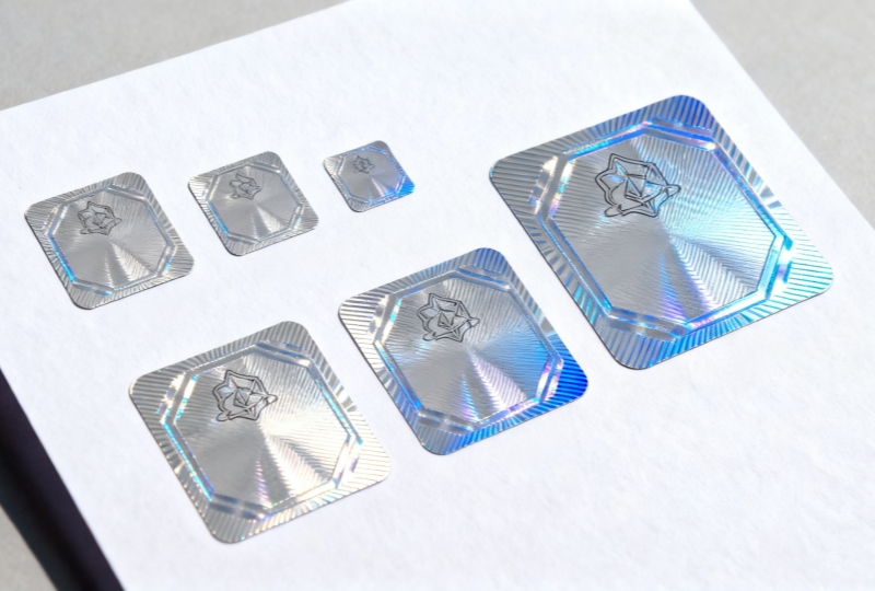 A comparison of custom security label sizes from GemmyLabel, showing small, medium, and large dimensions.